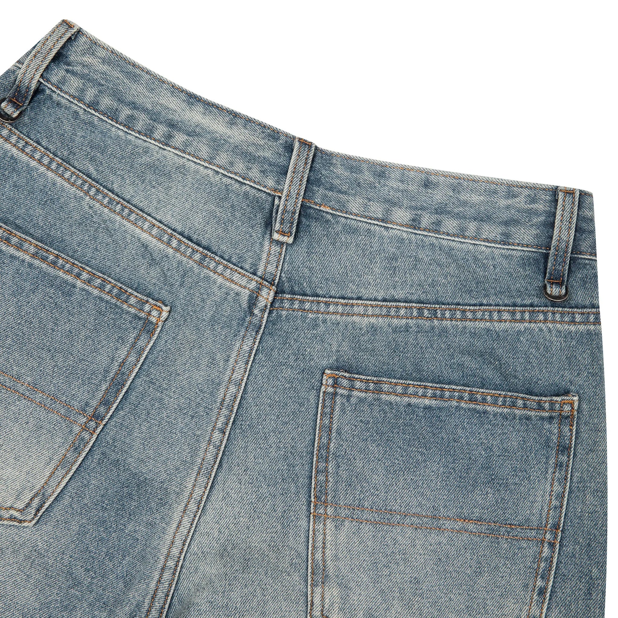 Close-up of the back waistband and rear pockets of light blue denim jeans on a plain white background.