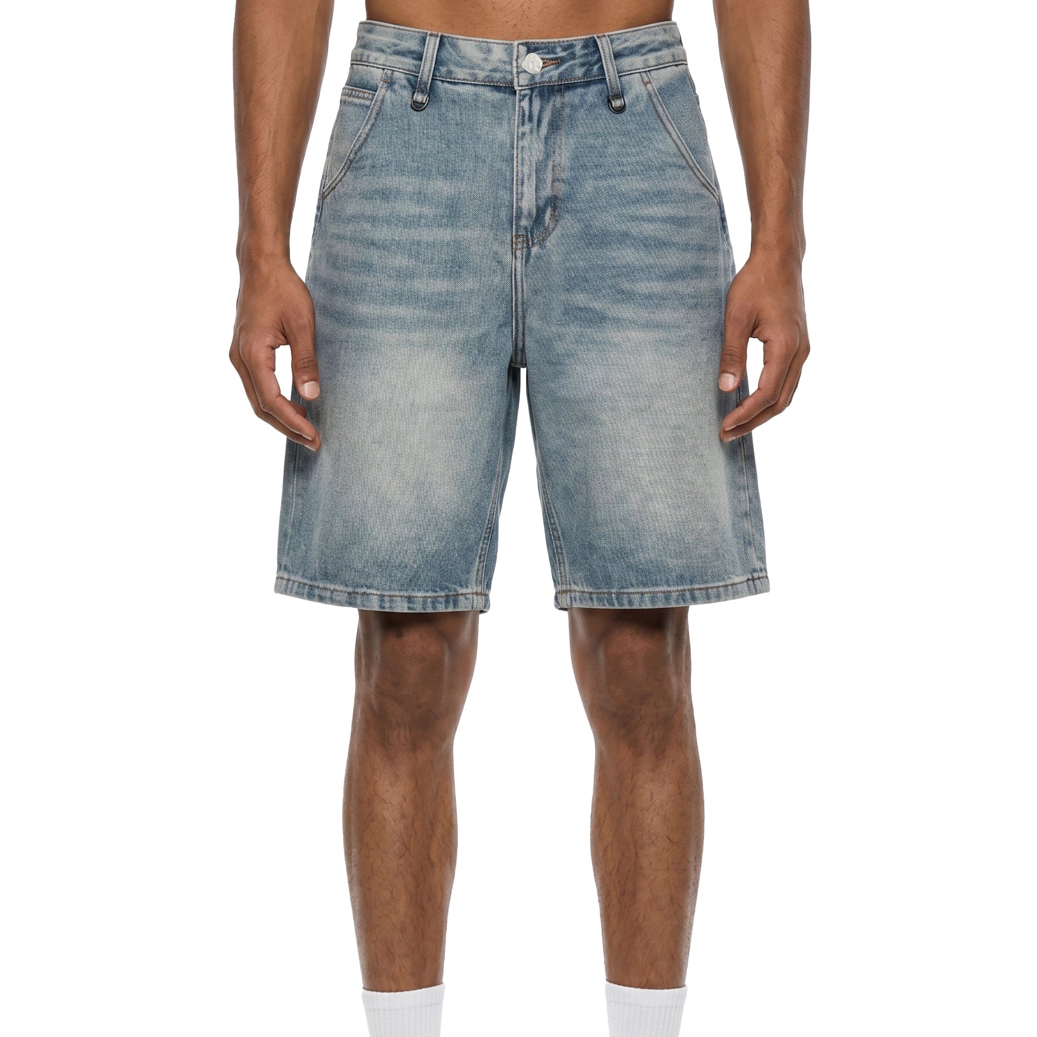 A person wearing light-wash blue denim shorts against a plain white studio background.