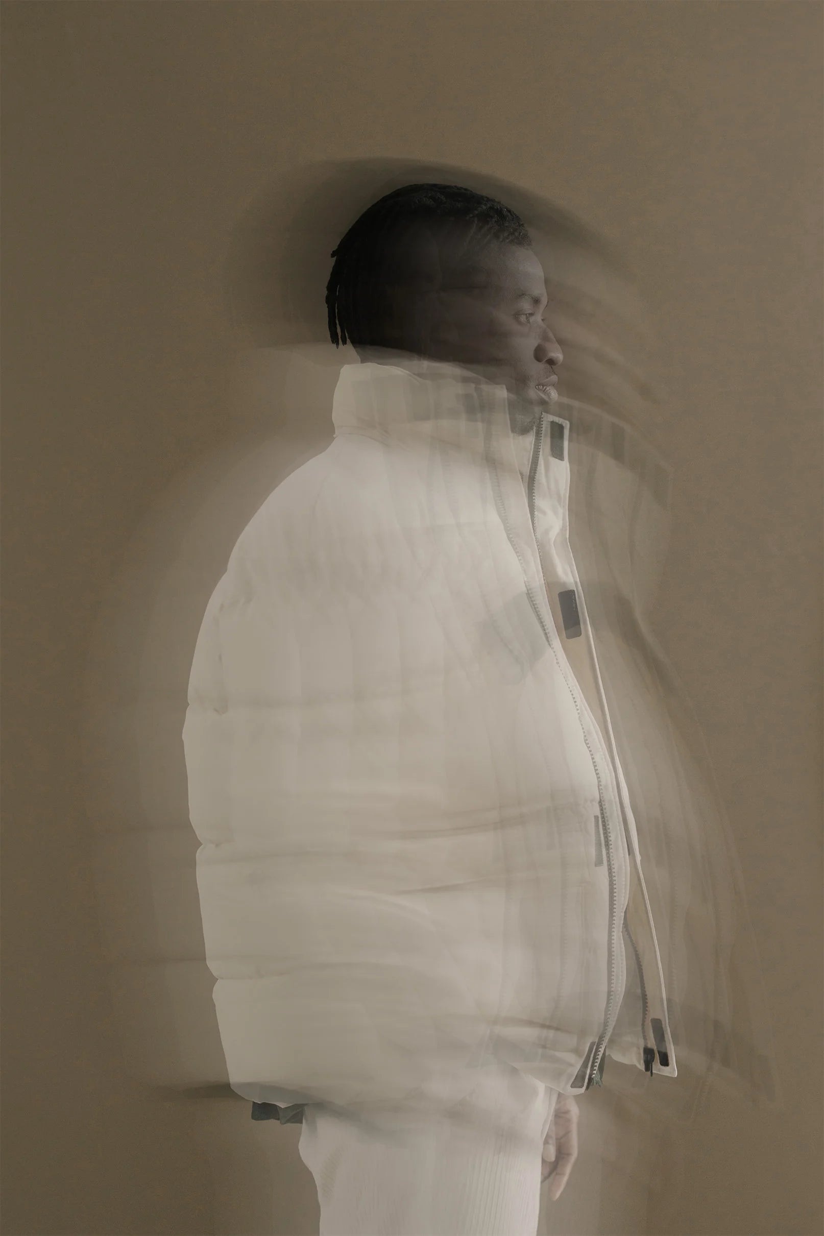 A man standing sideways, with motion blur around him