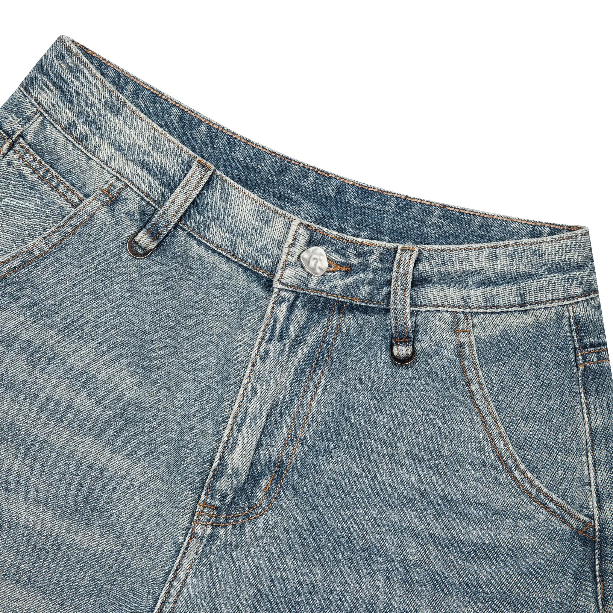 Close-up of the waistband and front closure of light blue denim jean shorts, showing belt loops, button, fly, and part of the pocket seams on a white background.