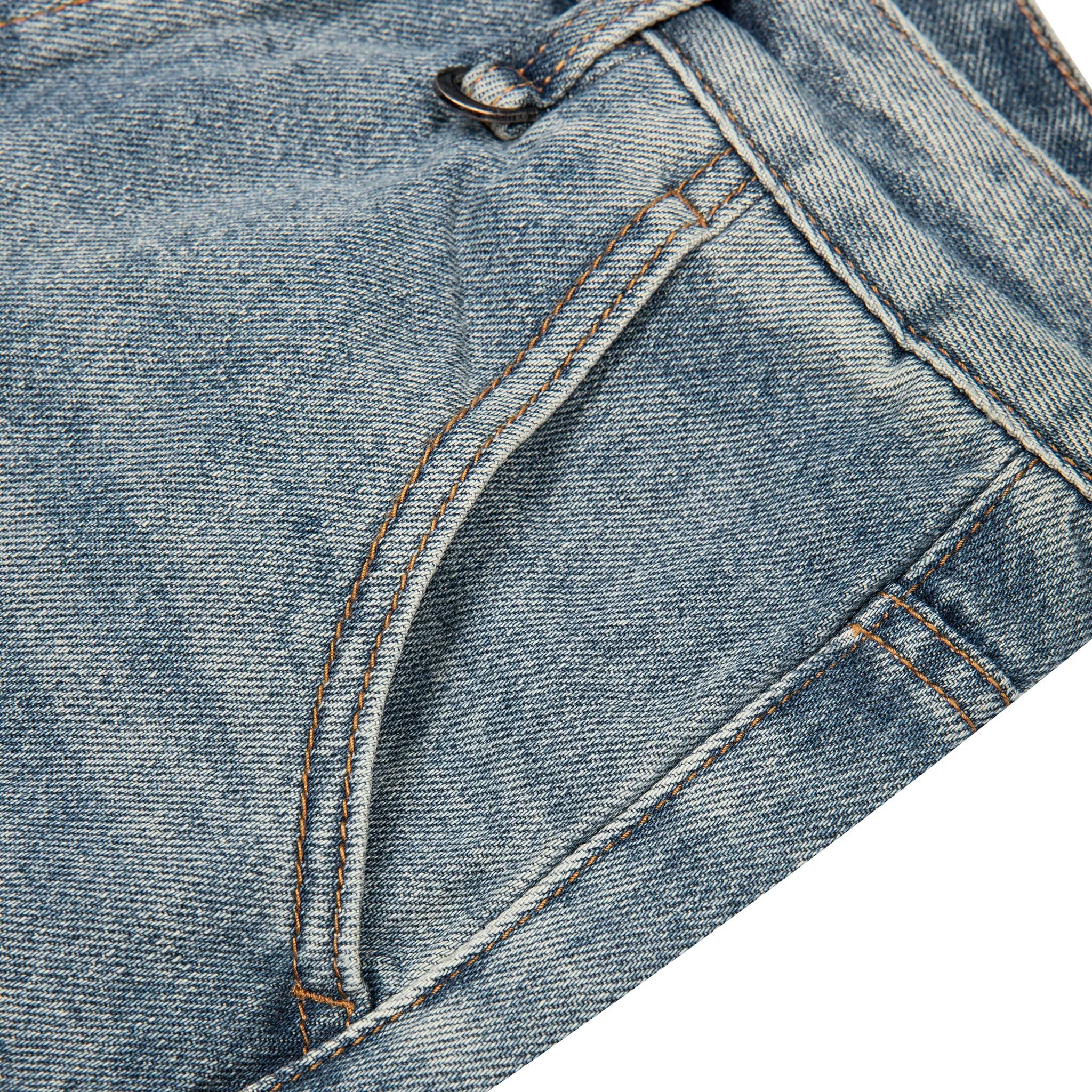Close-up detail of a pair of light-wash blue denim jean shorts showing the front pocket, stitching, and button area against a white background.